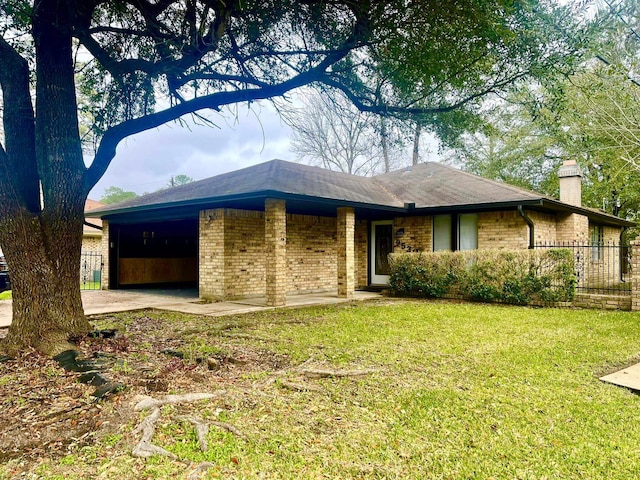 ranch-style home featuring a garage and a front yard