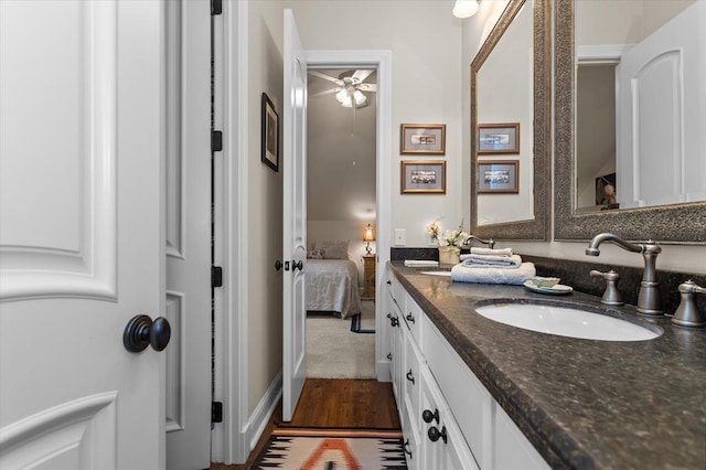 bathroom with hardwood / wood-style flooring, vanity, and ceiling fan