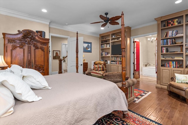 bedroom with wood-type flooring, ceiling fan with notable chandelier, ensuite bath, and crown molding