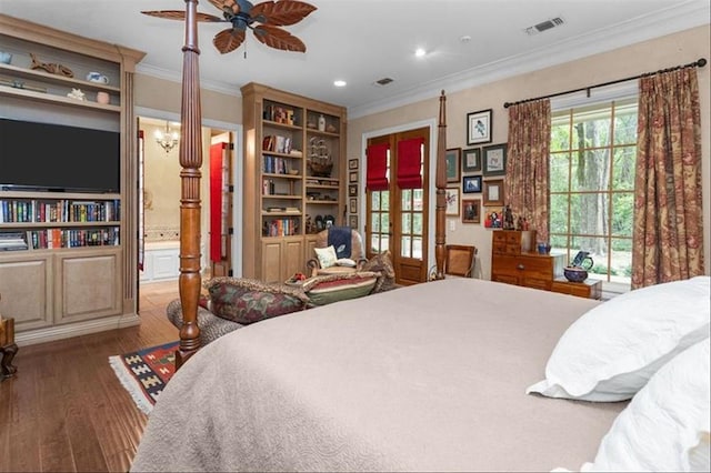 bedroom featuring hardwood / wood-style floors, ensuite bathroom, ceiling fan, and crown molding