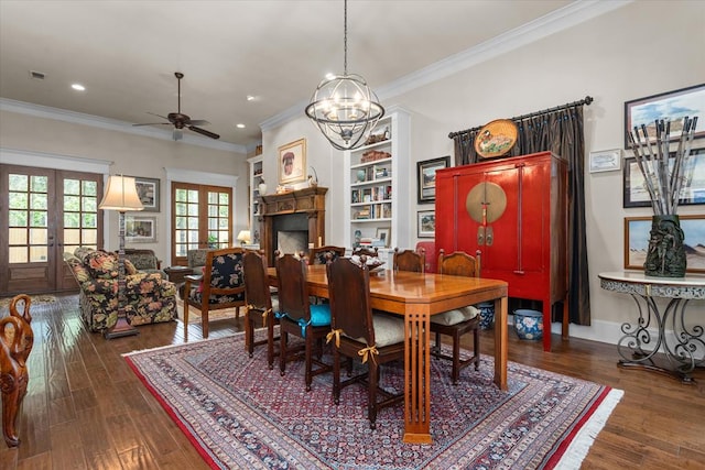 dining room featuring french doors, dark wood-type flooring, ceiling fan with notable chandelier, and ornamental molding