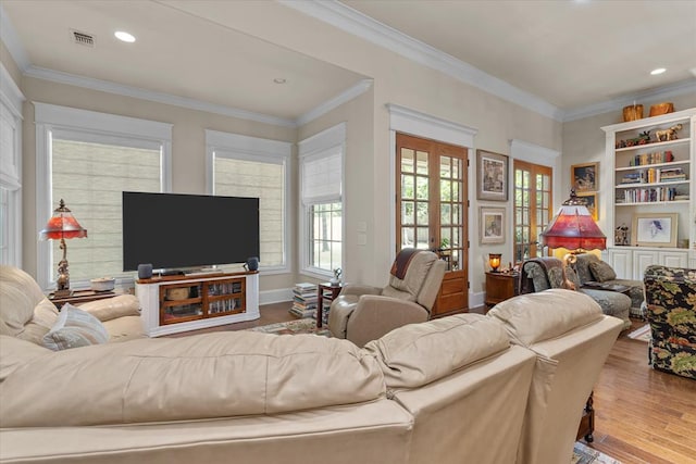 living room with crown molding and light hardwood / wood-style floors