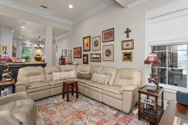 living room with a chandelier and crown molding