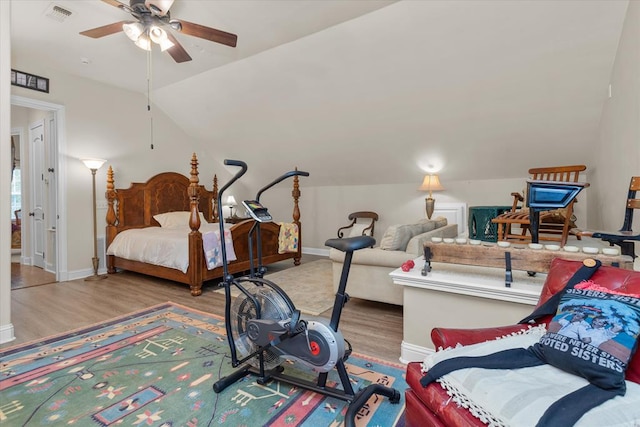 bedroom featuring hardwood / wood-style floors, ceiling fan, and lofted ceiling