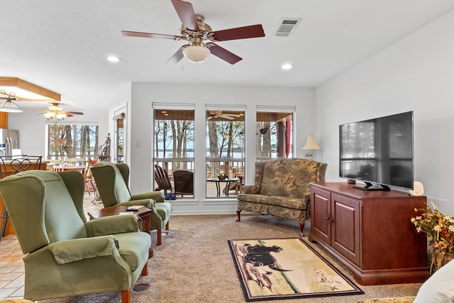 tiled living room featuring ceiling fan