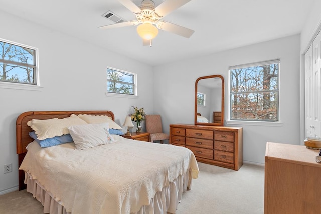 carpeted bedroom featuring ceiling fan and a closet