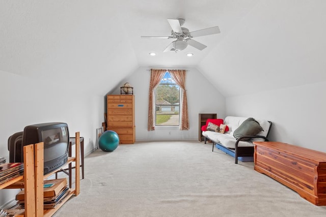 living area featuring ceiling fan, carpet, and lofted ceiling