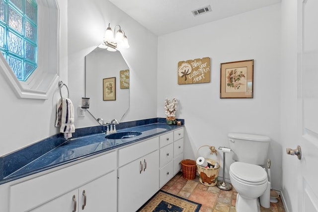 bathroom featuring toilet and vanity