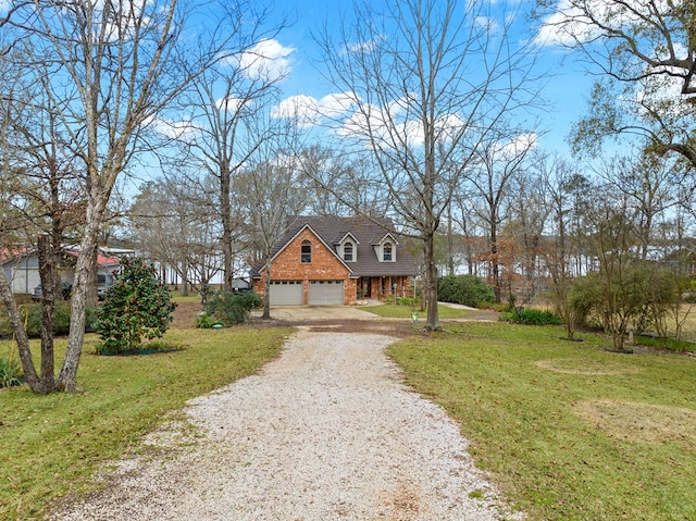 view of front of home with a front yard and a garage