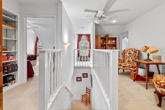 staircase with carpet and built in shelves