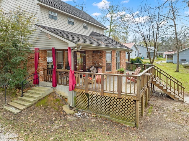 rear view of house with a wooden deck