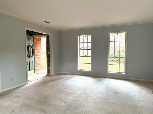 carpeted spare room with crown molding