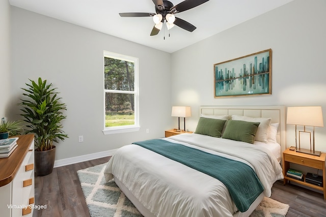 bedroom featuring wood finished floors, a ceiling fan, and baseboards