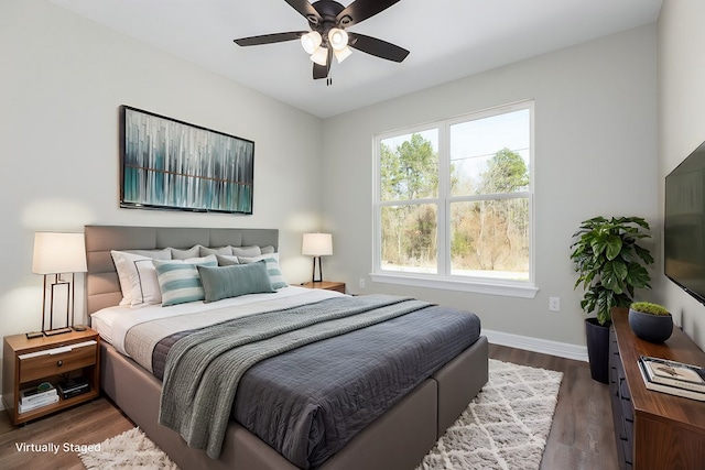 bedroom with ceiling fan, dark wood finished floors, and baseboards