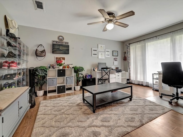 home office with ceiling fan and light hardwood / wood-style floors