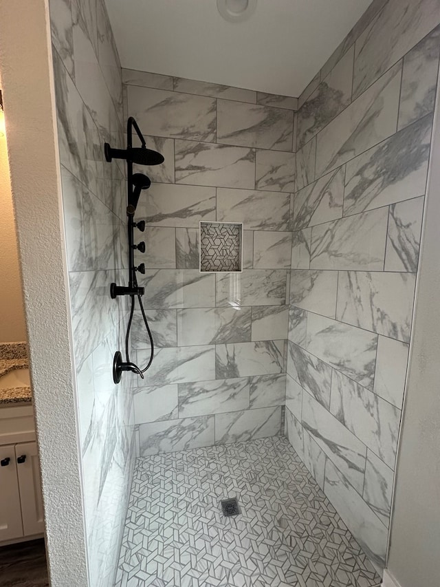 bathroom with a tile shower