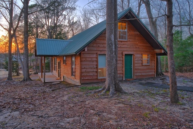 property exterior at dusk with metal roof