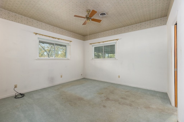 empty room with light colored carpet and ceiling fan