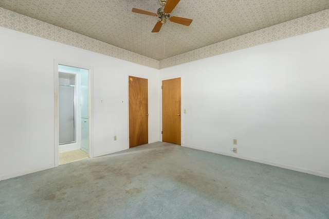 spare room featuring ceiling fan and carpet floors