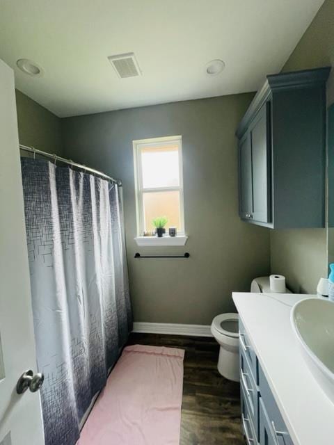 bathroom featuring hardwood / wood-style flooring, vanity, and toilet