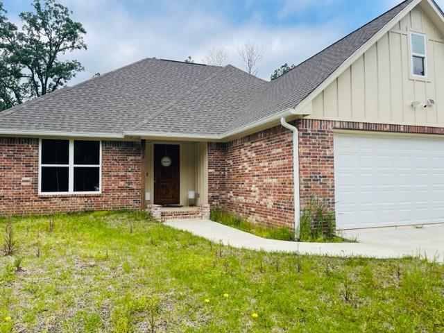 ranch-style house with a front lawn and a garage