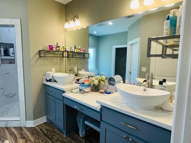 bathroom with vanity, hardwood / wood-style flooring, and walk in shower