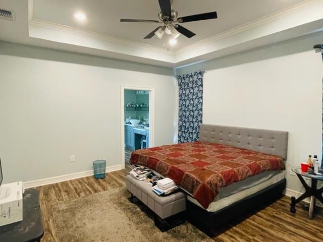 bedroom with hardwood / wood-style floors, ceiling fan, crown molding, and ensuite bathroom