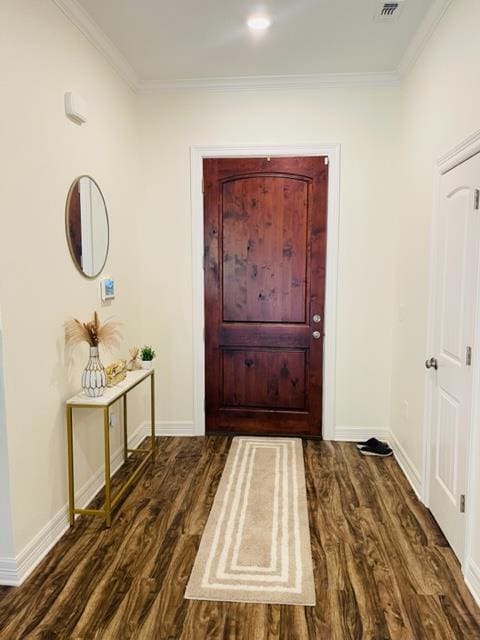 foyer entrance with dark hardwood / wood-style flooring and ornamental molding