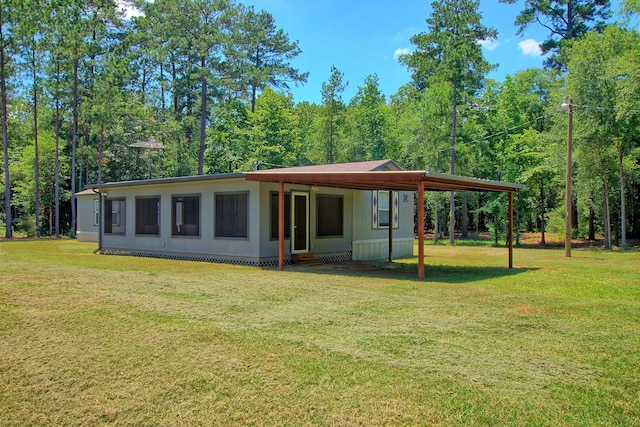 rear view of house featuring a lawn