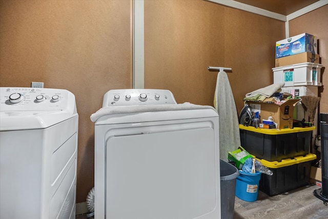 clothes washing area featuring independent washer and dryer and wood-type flooring