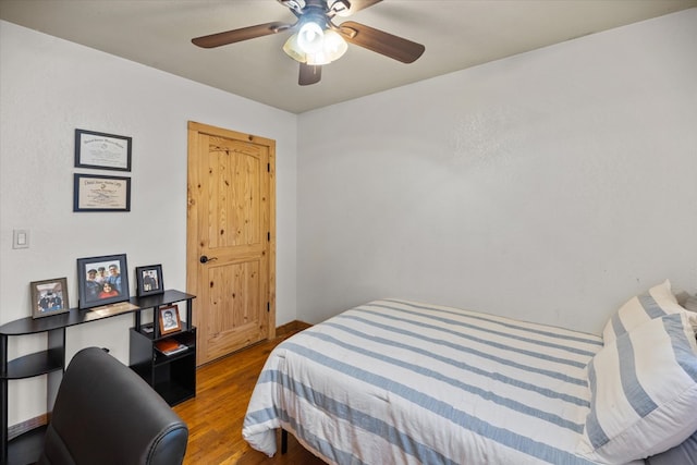 bedroom with wood-type flooring and ceiling fan