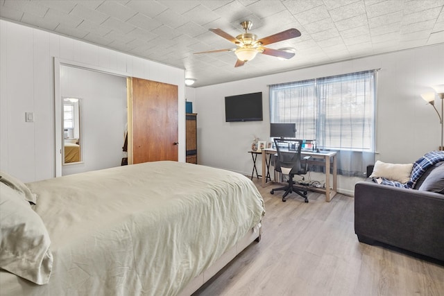 bedroom featuring ceiling fan and light hardwood / wood-style flooring