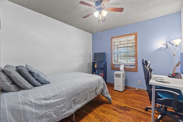 bedroom featuring hardwood / wood-style floors and ceiling fan