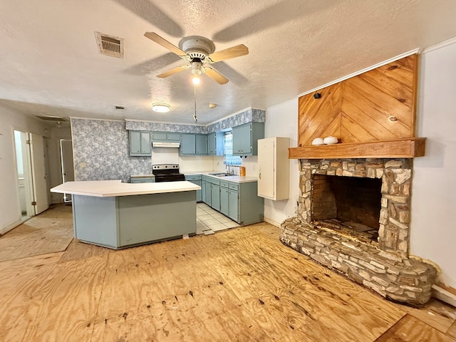 kitchen with black range with electric stovetop, sink, a textured ceiling, and kitchen peninsula