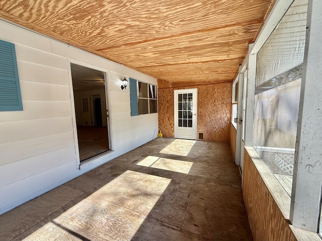 unfurnished sunroom featuring wooden ceiling