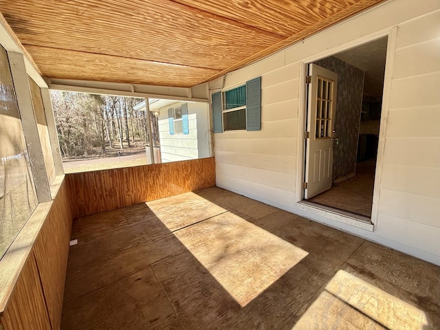 unfurnished sunroom featuring wooden ceiling