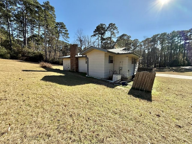 view of side of property with a yard