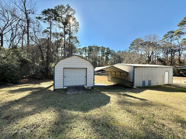 garage with a carport and a yard
