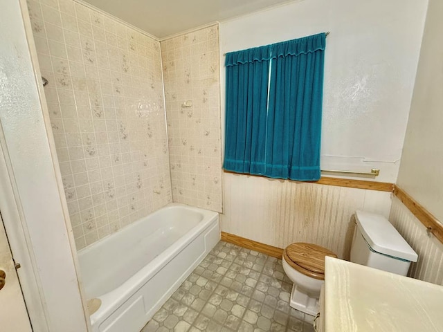 bathroom featuring a tub to relax in and toilet