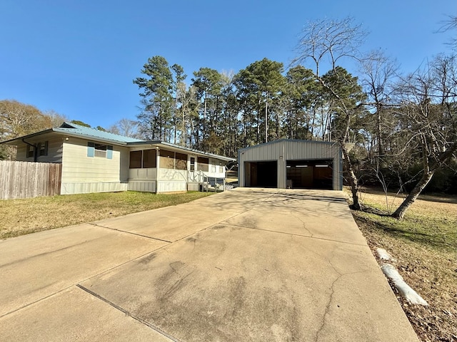 exterior space featuring an outbuilding, a garage, and a front yard