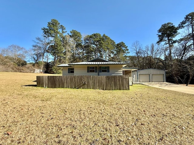 exterior space featuring a garage and a lawn