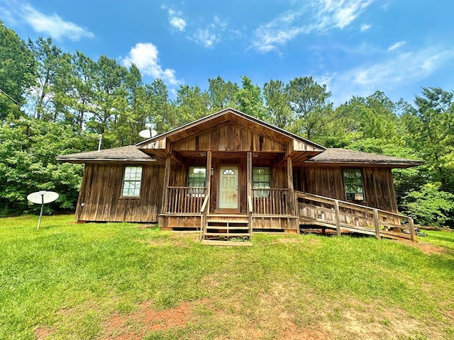 677 County Road 105, San Augustine, TX 75972 - view of front facade with a front yard and covered porch