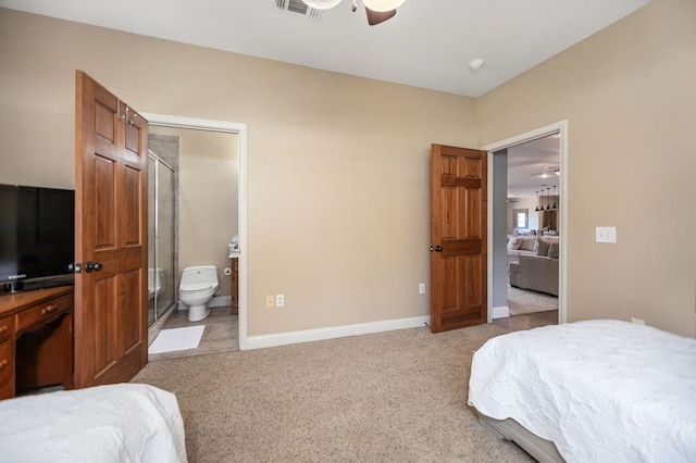 carpeted bedroom featuring ensuite bath, a ceiling fan, baseboards, and visible vents