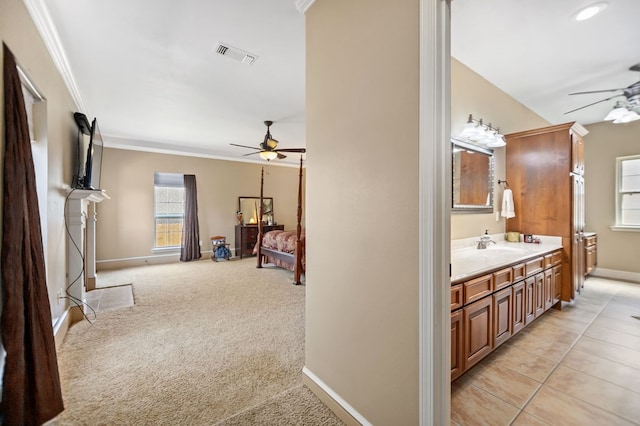 bathroom featuring baseboards, a ceiling fan, and crown molding