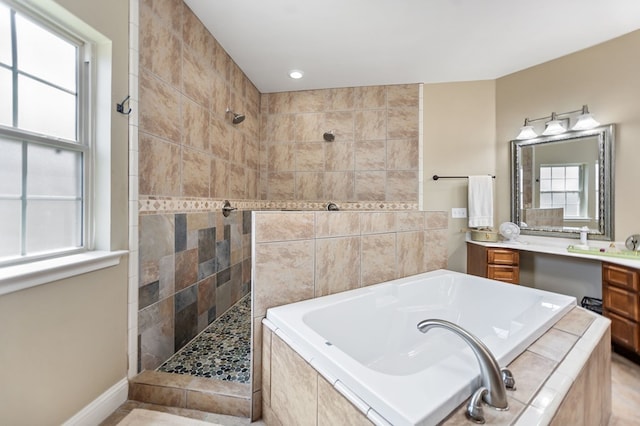 bathroom with recessed lighting, walk in shower, a garden tub, and vanity