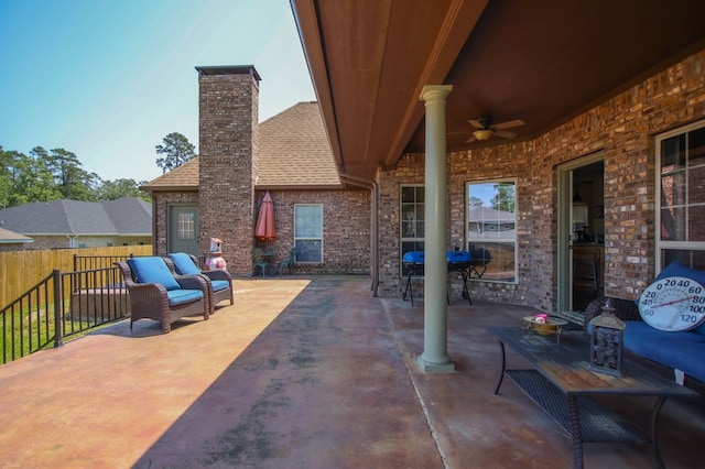 view of patio featuring fence and ceiling fan