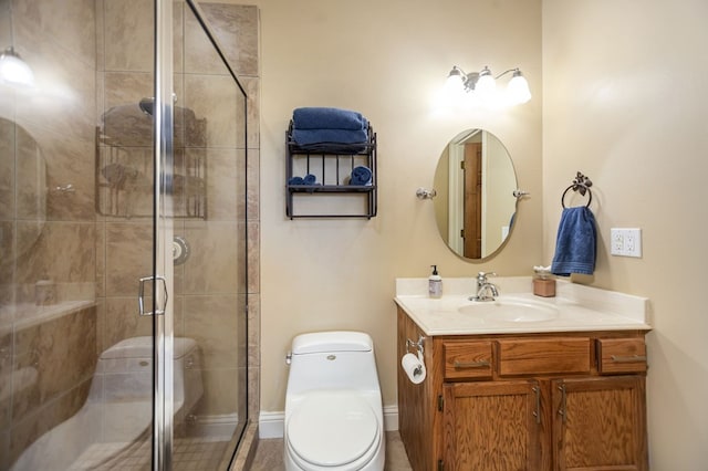 bathroom with a stall shower, vanity, and toilet
