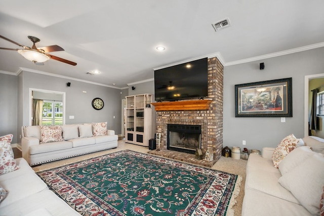 living area with a ceiling fan, visible vents, a fireplace, and ornamental molding