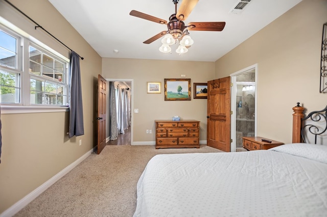 bedroom featuring a ceiling fan, a spacious closet, light carpet, baseboards, and visible vents