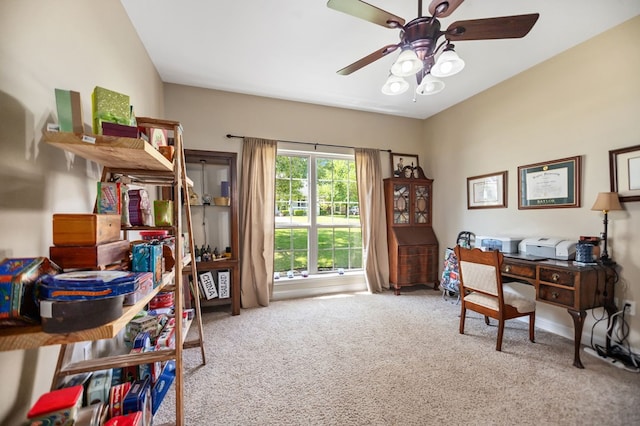 carpeted home office with baseboards and ceiling fan